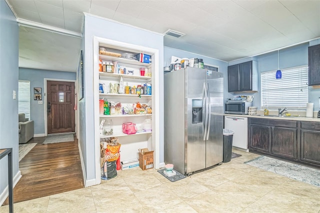 418 NW 27th Ter, Gainesville, FL 32607 - kitchen with stainless steel appliances, light countertops, and light tile patterned floors