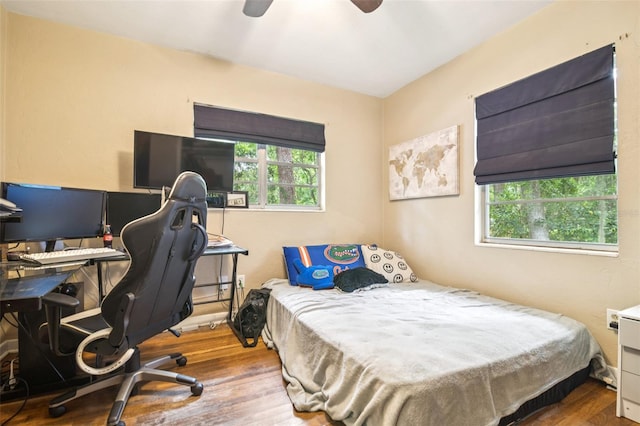 418 NW 27th Ter, Gainesville, FL 32607 - bedroom featuring wood finished floors, an office area, and ceiling fan