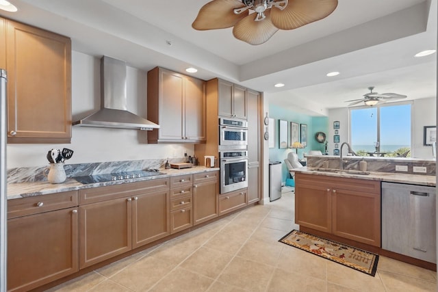 20 Porto Mar Unit 302, Palm Coast, FL 32137 - kitchen with appliances with stainless steel finishes, wall chimney exhaust hood, a ceiling fan, recessed lighting, and light stone counters