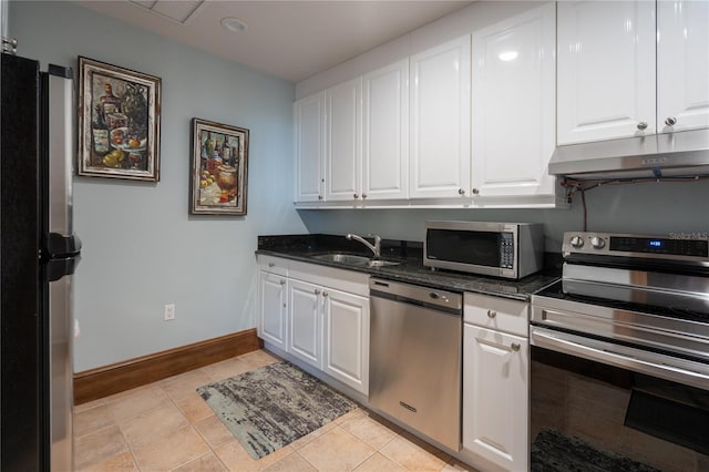 20 Porto Mar Unit 302, Palm Coast, FL 32137 - kitchen featuring appliances with stainless steel finishes, under cabinet range hood, white cabinets, and light tile patterned flooring