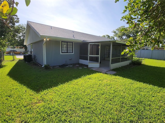 1810 Western Rd, South Daytona, FL 32119 - rear view of property featuring a sunroom, a gate, and roof with shingles