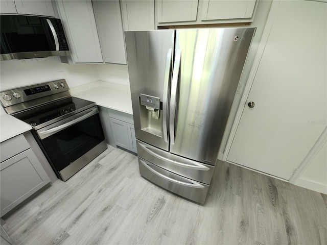 1810 Western Rd, South Daytona, FL 32119 - kitchen featuring stainless steel appliances, light wood-style flooring, gray cabinetry, and light countertops
