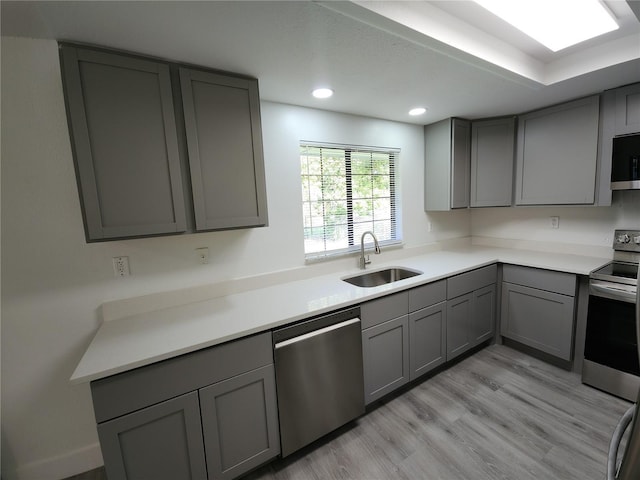1810 Western Rd, South Daytona, FL 32119 - kitchen with gray cabinetry, appliances with stainless steel finishes, light wood-style flooring, recessed lighting, and light countertops