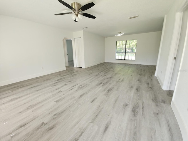 1810 Western Rd, South Daytona, FL 32119 - spare room with light wood finished floors, a ceiling fan, and arched walkways