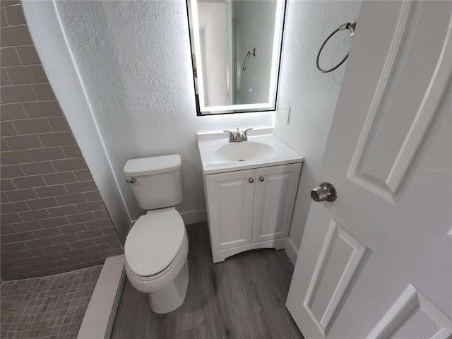 1810 Western Rd, South Daytona, FL 32119 - full bathroom with vanity, wood finished floors, and tiled shower