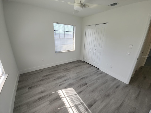 1810 Western Rd, South Daytona, FL 32119 - unfurnished bedroom featuring wood finished floors, a closet, and a ceiling fan