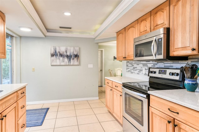 159 Southwind Cir, Saint Augustine, FL 32080 - kitchen featuring appliances with stainless steel finishes, tasteful backsplash, light countertops, light tile patterned flooring, and a raised ceiling