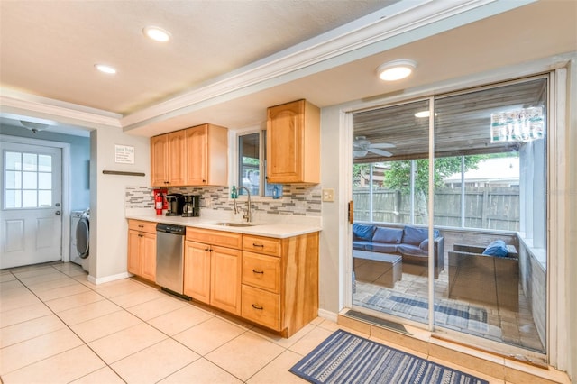 159 Southwind Cir, Saint Augustine, FL 32080 - kitchen with stainless steel dishwasher, washer / clothes dryer, light tile patterned flooring, light countertops, and decorative backsplash