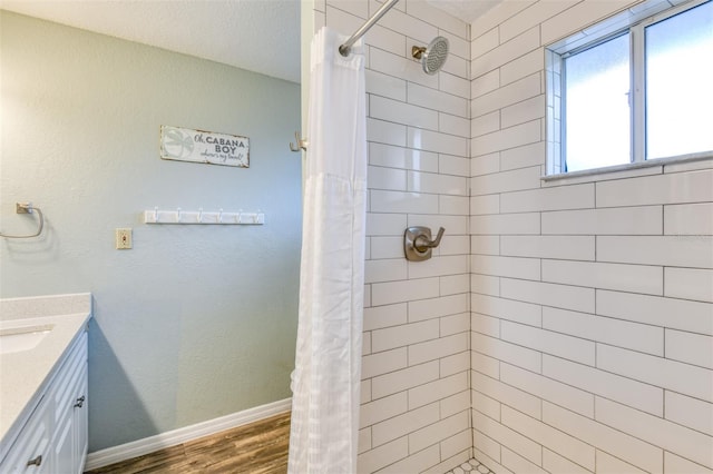 159 Southwind Cir, Saint Augustine, FL 32080 - bathroom with wood finished floors, a tile shower, and vanity