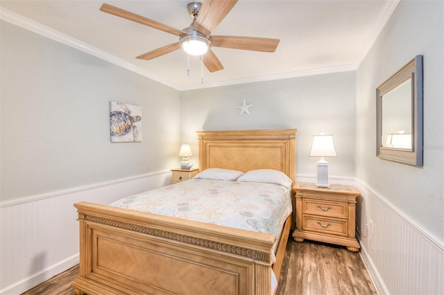 159 Southwind Cir, Saint Augustine, FL 32080 - bedroom featuring wood finished floors, wainscoting, ornamental molding, and a ceiling fan