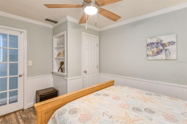 159 Southwind Cir, Saint Augustine, FL 32080 - bedroom featuring a wainscoted wall, wood finished floors, ornamental molding, and a ceiling fan
