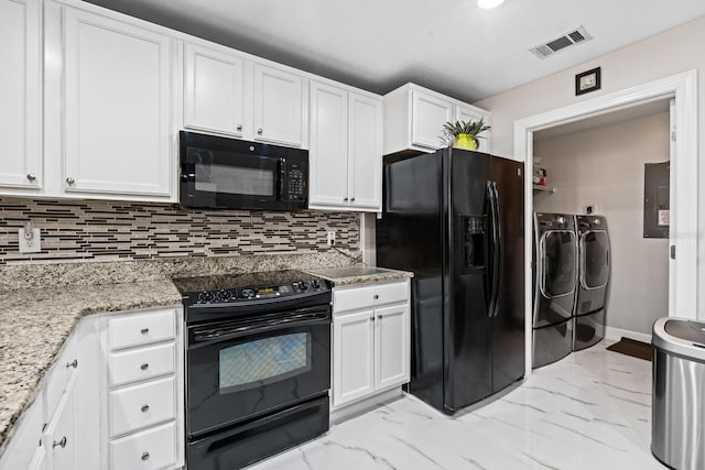 100 Bella Harbor Ct Unit 103, Palm Coast, FL 32137 - kitchen with black appliances, washing machine and clothes dryer, white cabinetry, and decorative backsplash