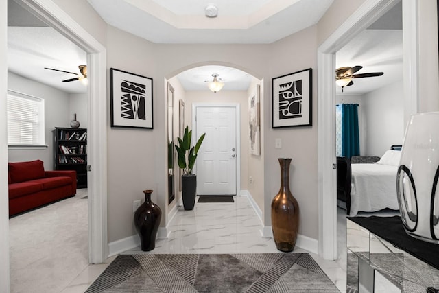 100 Bella Harbor Ct Unit 103, Palm Coast, FL 32137 - foyer with arched walkways, a ceiling fan, and light marble finish floors