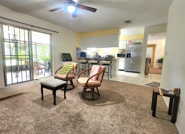 1561 Copperfield Ave, Deltona, FL 32738 - sitting room featuring light colored carpet, a ceiling fan, a textured ceiling, and light tile patterned floors