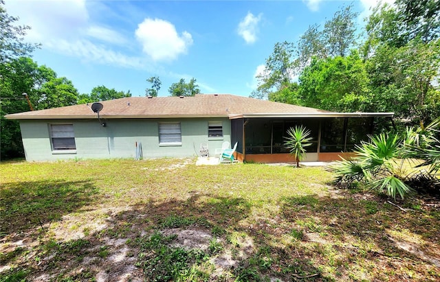 1561 Copperfield Ave, Deltona, FL 32738 - rear view of property with a sunroom, a lawn, concrete block siding, and roof with shingles