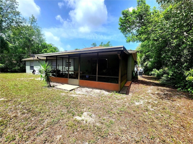 1561 Copperfield Ave, Deltona, FL 32738 - back of property with a sunroom and a yard