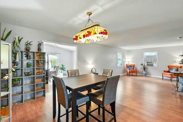 29 Rylin Ln, Palm Coast, FL 32164 - dining area featuring wood finished floors, a textured ceiling, and cooling unit
