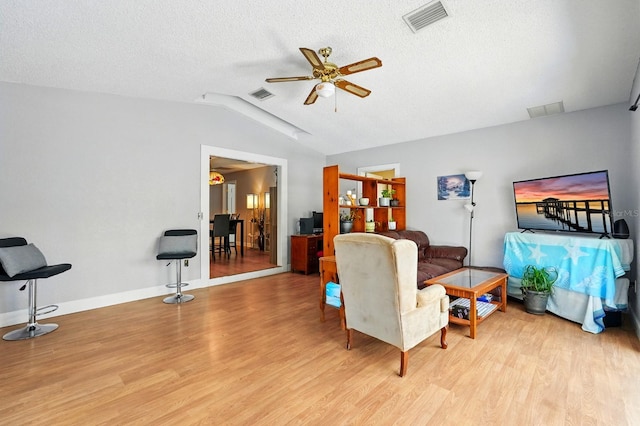 29 Rylin Ln, Palm Coast, FL 32164 - living area featuring vaulted ceiling, wood finished floors, a ceiling fan, and a textured ceiling
