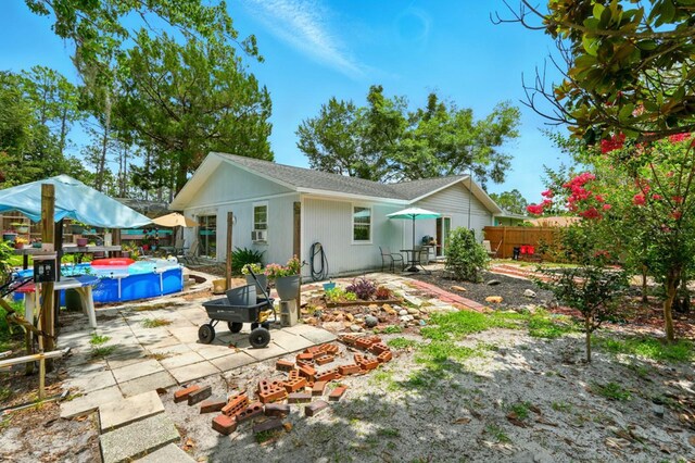 29 Rylin Ln, Palm Coast, FL 32164 - back of house featuring a patio area, an outdoor pool, and a fenced backyard