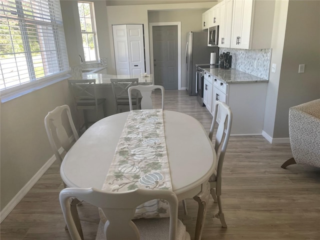 2 Unity Ct, Palm Coast, FL 32164 - dining space with baseboards and light wood-type flooring