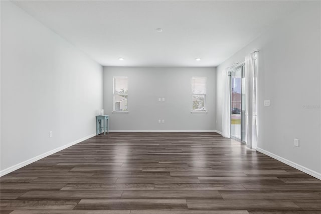 51 Oakleaf Way, Palm Coast, FL 32137 - spare room featuring dark wood-style floors and recessed lighting