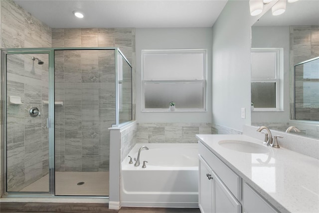 51 Oakleaf Way, Palm Coast, FL 32137 - full bathroom with vanity, a garden tub, and a stall shower