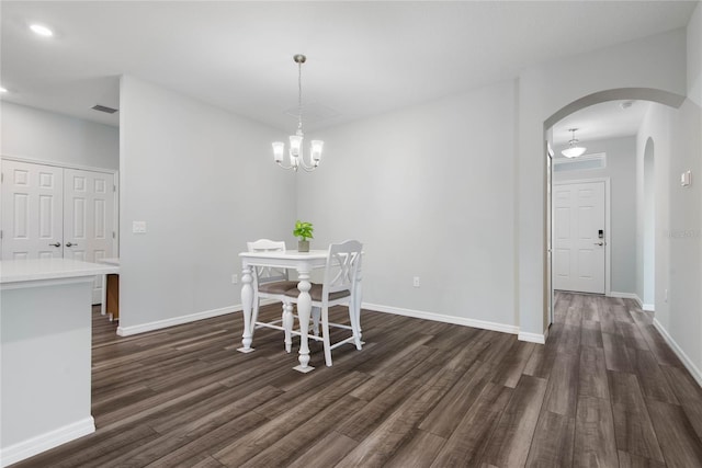 51 Oakleaf Way, Palm Coast, FL 32137 - dining space featuring arched walkways, dark wood-style flooring, and a chandelier