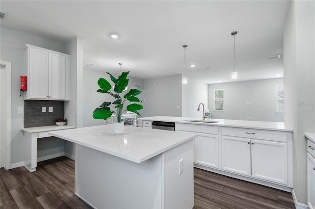 51 Oakleaf Way, Palm Coast, FL 32137 - kitchen with a kitchen island, dark wood-style flooring, white cabinets, a peninsula, and recessed lighting