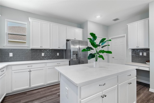 51 Oakleaf Way, Palm Coast, FL 32137 - kitchen with stainless steel fridge with ice dispenser, dark wood-style flooring, tasteful backsplash, white cabinets, and recessed lighting