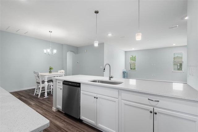 51 Oakleaf Way, Palm Coast, FL 32137 - kitchen with stainless steel dishwasher, arched walkways, dark wood-type flooring, white cabinets, and hanging light fixtures