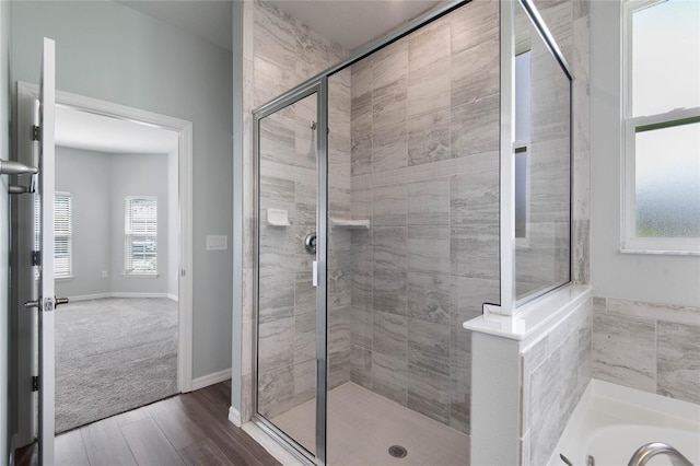 51 Oakleaf Way, Palm Coast, FL 32137 - bathroom featuring a stall shower, wood finished floors, and a garden tub