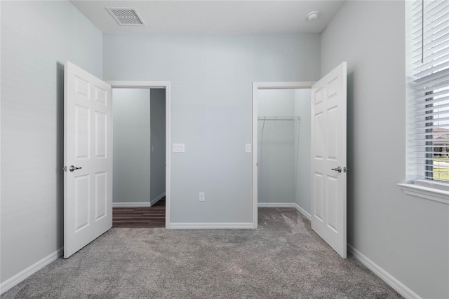 51 Oakleaf Way, Palm Coast, FL 32137 - unfurnished bedroom with carpet floors, a spacious closet, and a closet