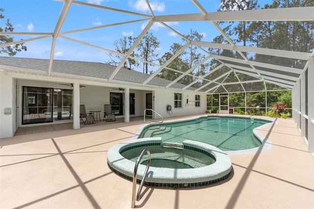 57 Prattwood Ln, Palm Coast, FL 32164 - view of swimming pool featuring ceiling fan, a patio, a pool with connected hot tub, and glass enclosure