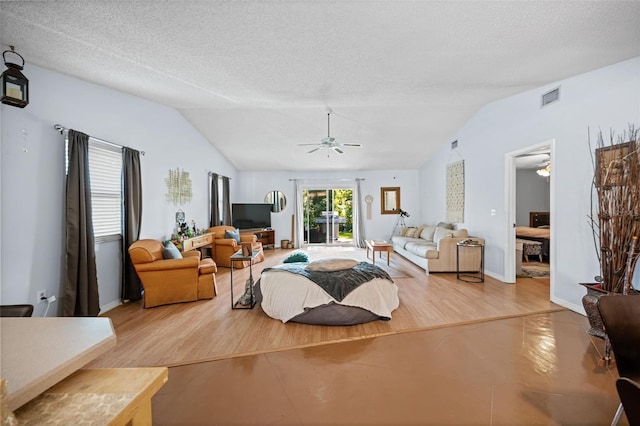152 Fenimore Ln Unit A & B, Palm Coast, FL 32137 - living room featuring vaulted ceiling, ceiling fan, a textured ceiling, and wood finished floors