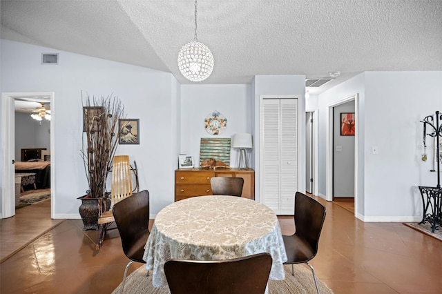152 Fenimore Ln Unit A & B, Palm Coast, FL 32137 - tiled dining area featuring a textured ceiling, a chandelier, and a ceiling fan