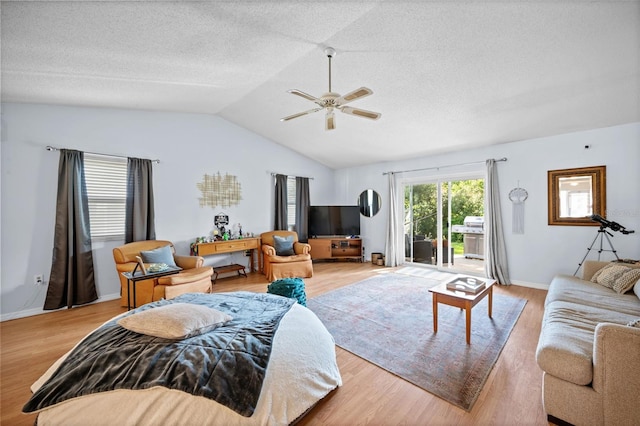 152 Fenimore Ln Unit A & B, Palm Coast, FL 32137 - living area with a ceiling fan, vaulted ceiling, light wood-style flooring, and a textured ceiling