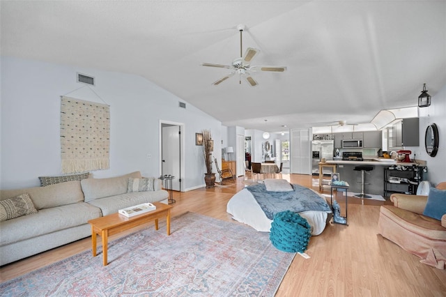 152 Fenimore Ln Unit A & B, Palm Coast, FL 32137 - living room featuring a ceiling fan, vaulted ceiling, and light wood-style floors