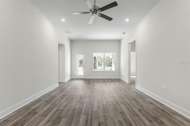 6 Bainbridge Ln, Palm Coast, FL 32137 - unfurnished living room with dark wood-style floors, a ceiling fan, and recessed lighting
