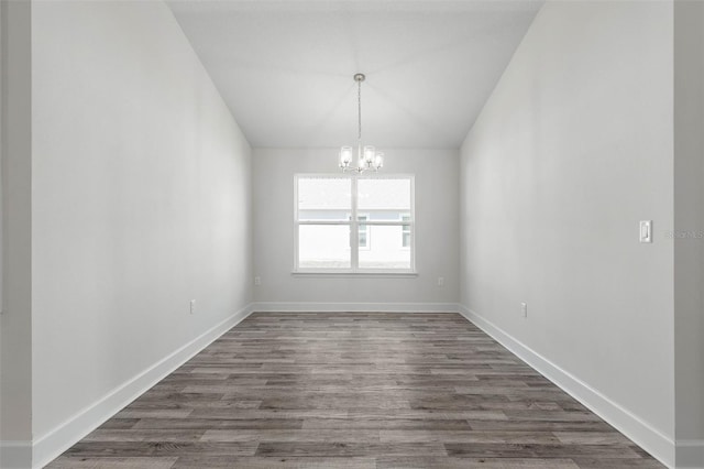 6 Bainbridge Ln, Palm Coast, FL 32137 - unfurnished dining area with a chandelier, vaulted ceiling, and dark wood-type flooring