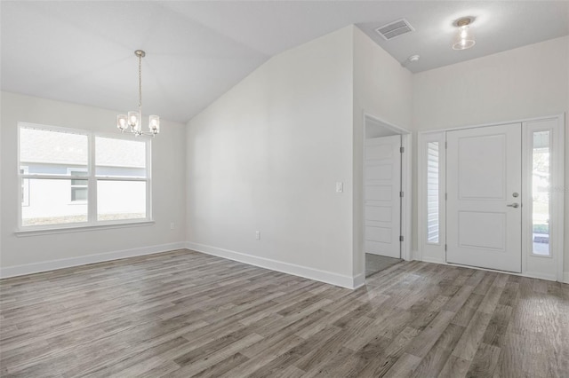 6 Bainbridge Ln, Palm Coast, FL 32137 - entrance foyer with a chandelier, wood finished floors, healthy amount of natural light, and vaulted ceiling
