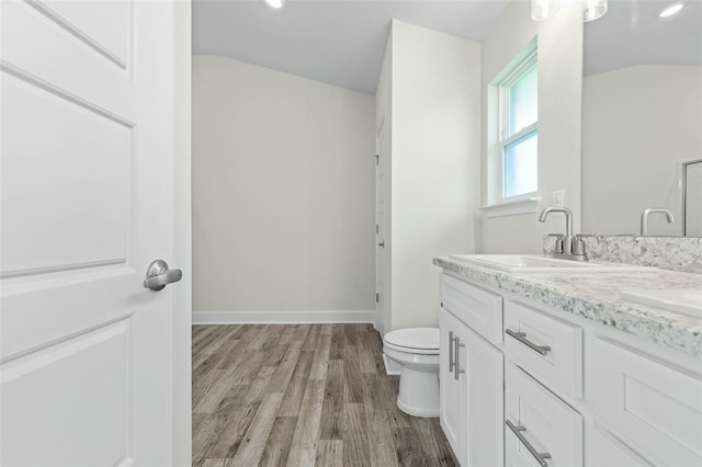 6 Bainbridge Ln, Palm Coast, FL 32137 - full bathroom with wood finished floors, vaulted ceiling, double vanity, and recessed lighting