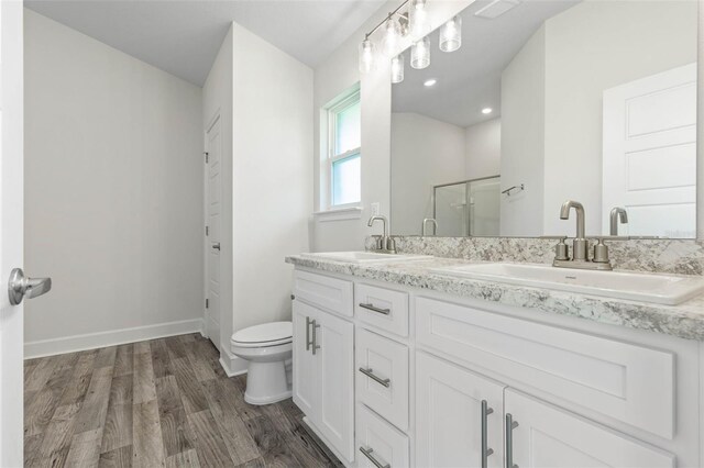 6 Bainbridge Ln, Palm Coast, FL 32137 - full bathroom featuring double vanity, wood finished floors, and a shower stall