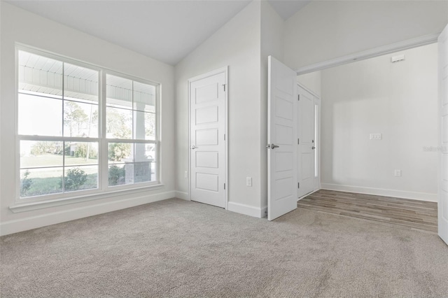 6 Bainbridge Ln, Palm Coast, FL 32137 - unfurnished bedroom featuring carpet floors and lofted ceiling