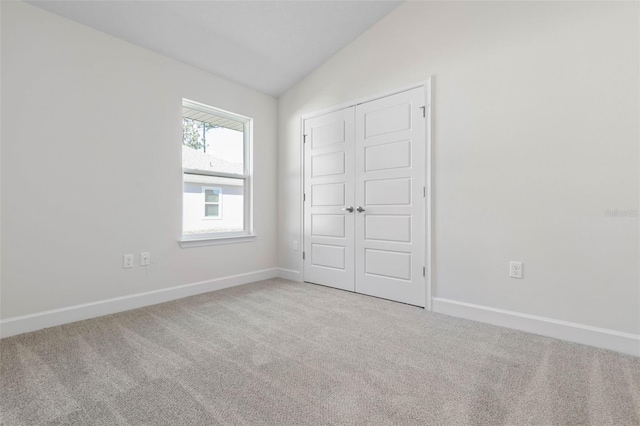 6 Bainbridge Ln, Palm Coast, FL 32137 - unfurnished bedroom featuring lofted ceiling, carpet floors, and a closet