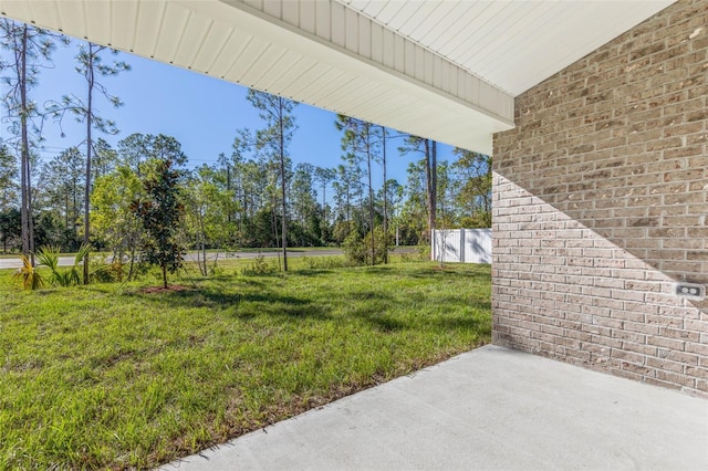 6 Bainbridge Ln, Palm Coast, FL 32137 - view of green lawn with a patio