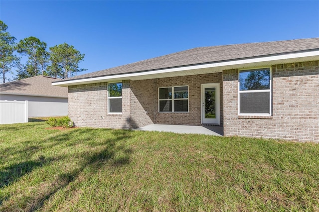 6 Bainbridge Ln, Palm Coast, FL 32137 - back of house with a patio area, brick siding, and a shingled roof