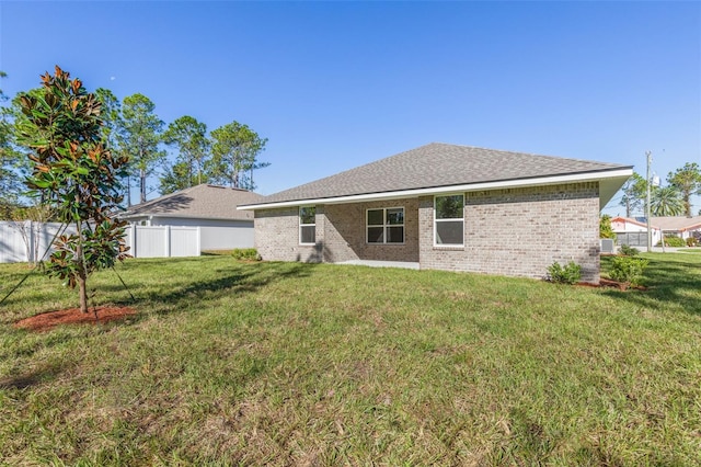 6 Bainbridge Ln, Palm Coast, FL 32137 - rear view of house featuring brick siding and a shingled roof