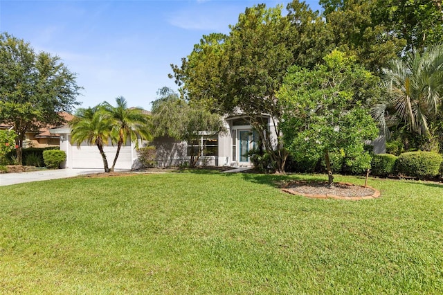 81 Brownstone Ln, Palm Coast, FL 32137 - view of property hidden behind natural elements featuring driveway, a garage, a front lawn, and stucco siding