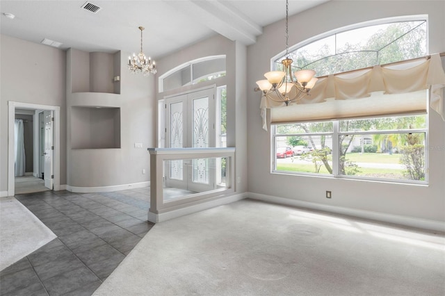 81 Brownstone Ln, Palm Coast, FL 32137 - foyer featuring a chandelier and a towering ceiling
