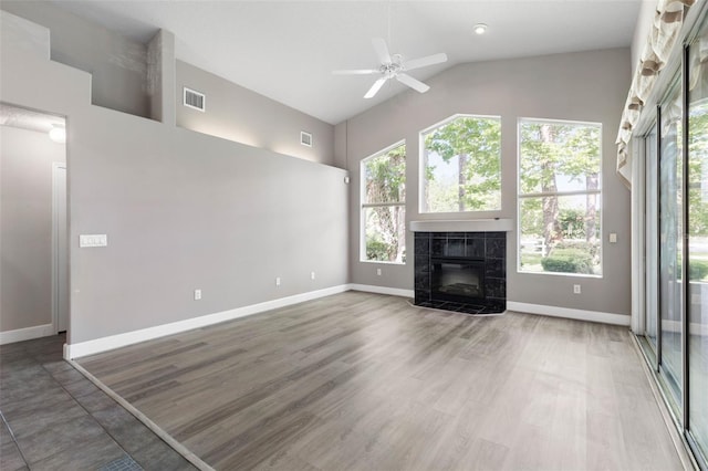 81 Brownstone Ln, Palm Coast, FL 32137 - unfurnished living room featuring a fireplace, high vaulted ceiling, a ceiling fan, and wood finished floors